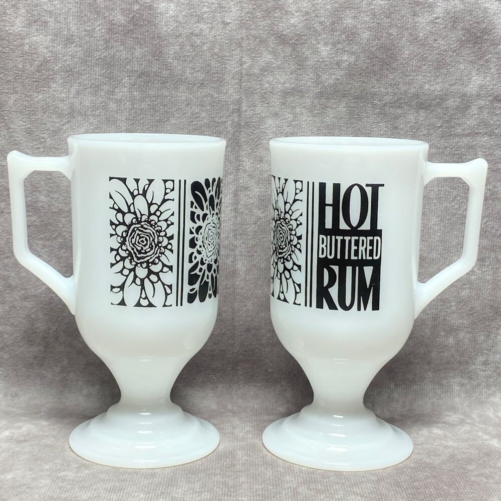2 Vintage Milk Glass "Hot Buttered Rum" Pedestal Mugs With Black Floral Design